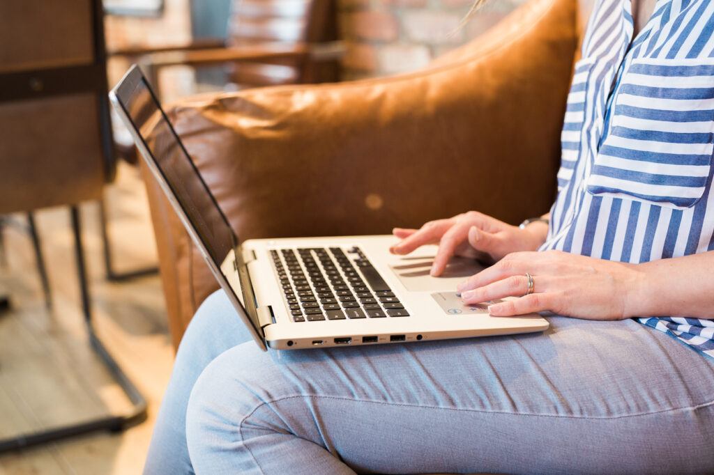 Eb typing on her laptop.