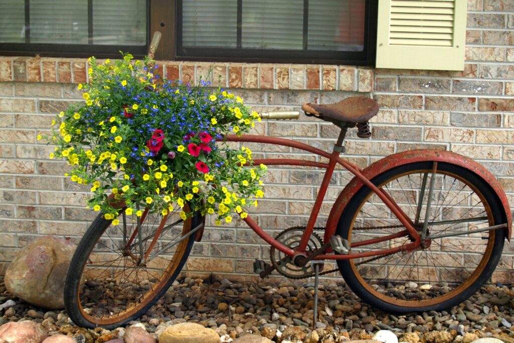 an old bicycle used as a flower planter