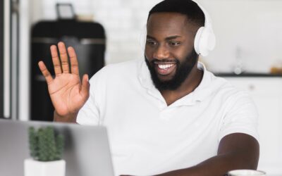 Man waving to his computer.